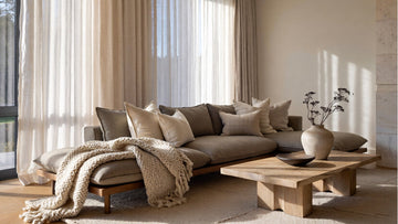 Living room styled with Belgian linen curtains, cushion covers, and textured throws in a modern minimalist interior