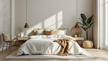 A cozy bedroom featuring a bed with linen sheets, a chair, and potted plants, complemented by linen curtains.