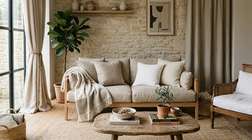 A warm living room styled with Belgian linen curtains, cushion covers, and a soft throw.