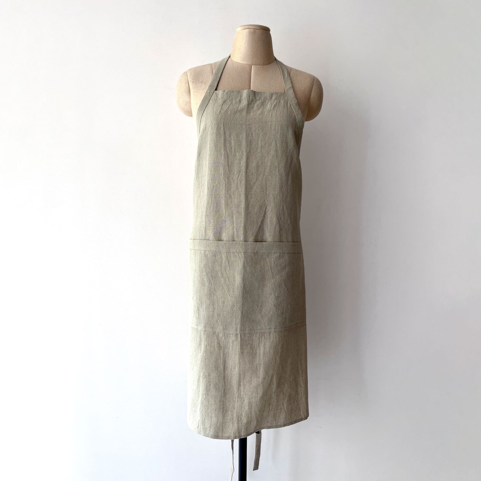 Beige straight arm linen apron front view