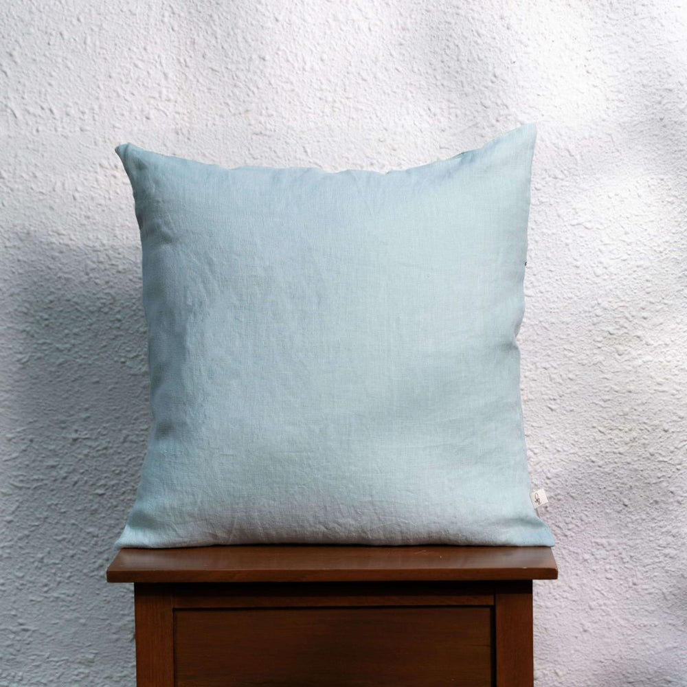 Blue Surf Linen Cushion Cover On a Wooden Table