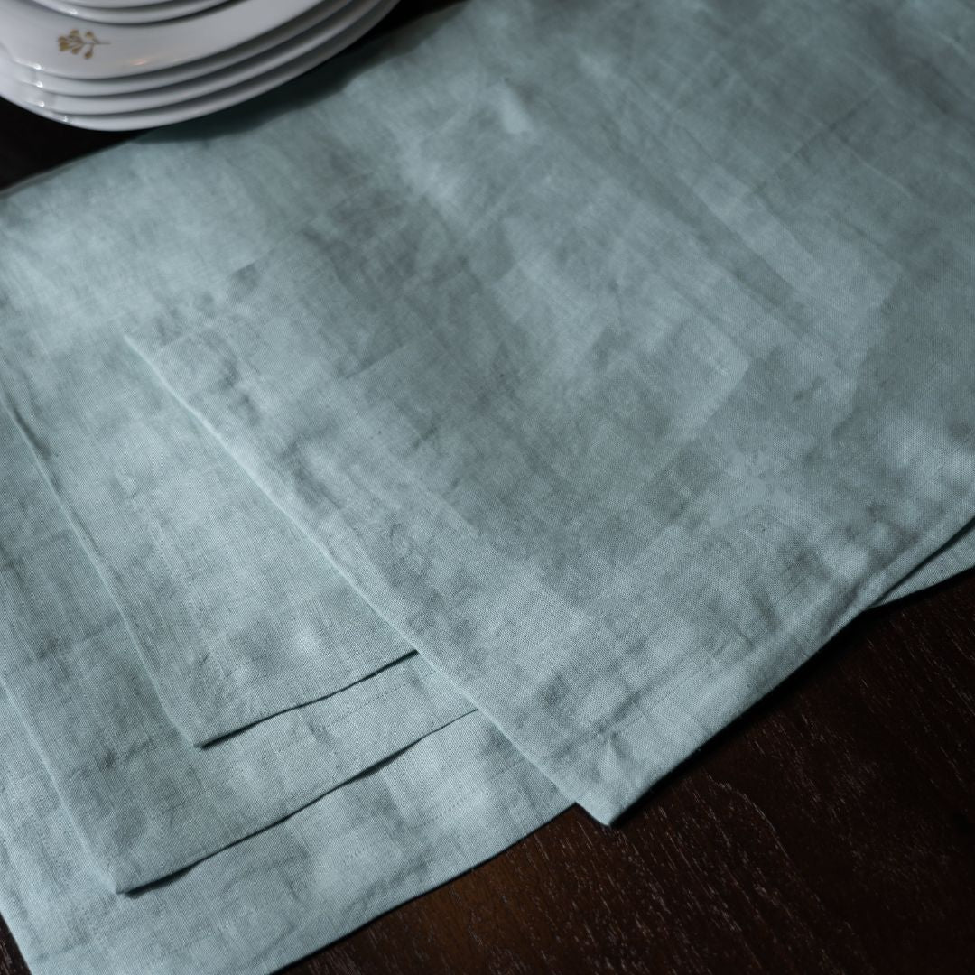 Blue Surf Linen Table Placemat On a Wooden Table