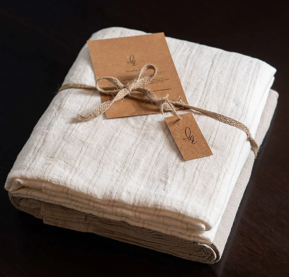 Folded fabric with brown tags on a dark background