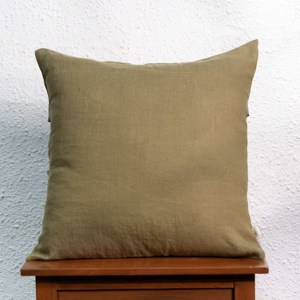 Green Moss Linen Cushion Cover On a Wooden Table