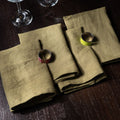 Green Moss Linen Napkins On a Wooden Table