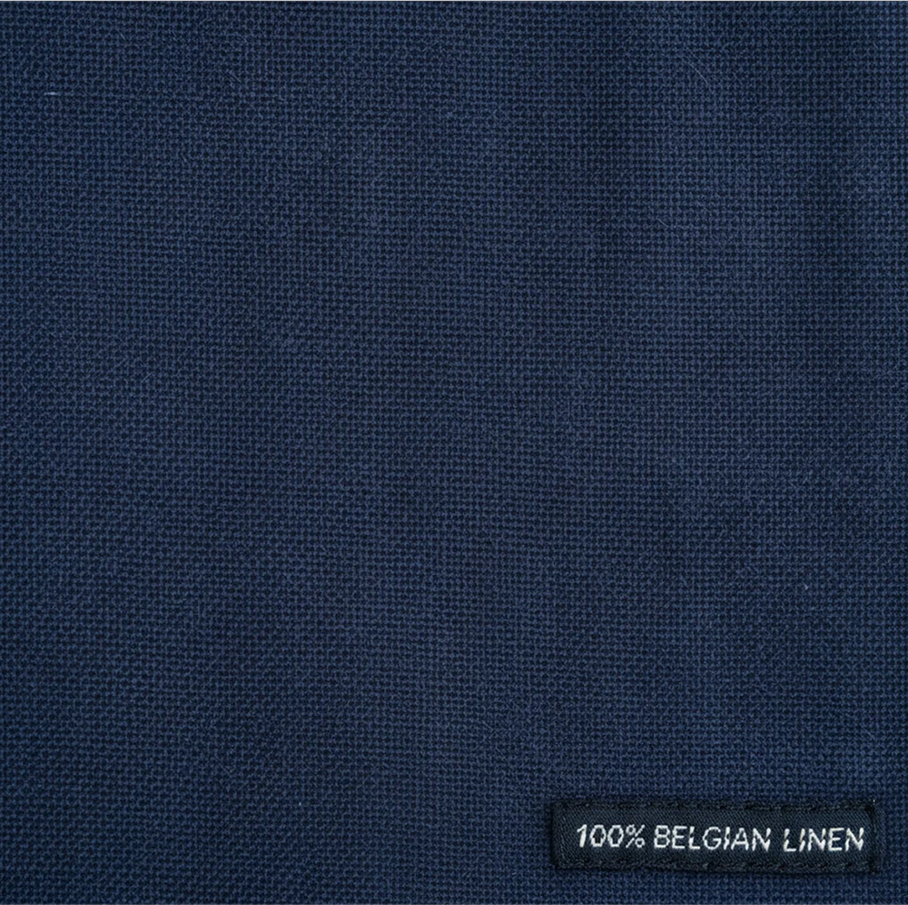 Navy blue fabric with a label indicating 100% Belgian linen.