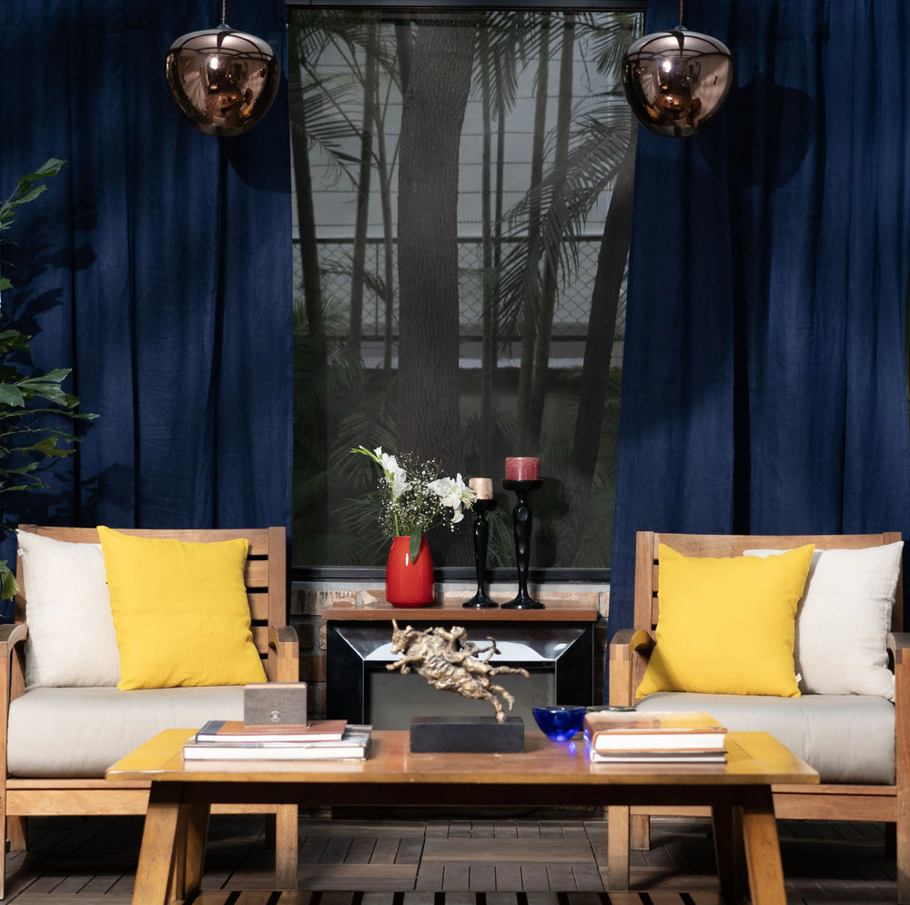 Modern living room with wooden furniture, yellow cushions, and decorative items.