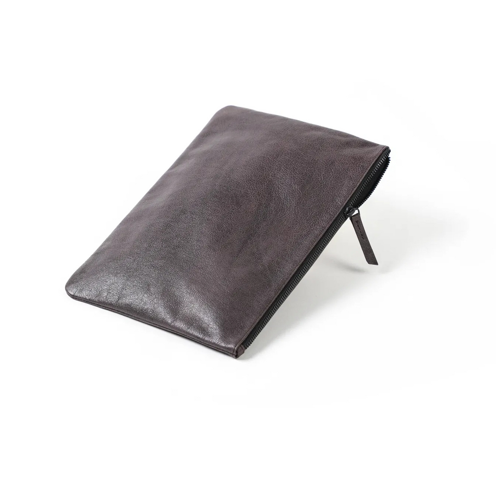 A dark brown genuine leather iPad cover with a textured surface