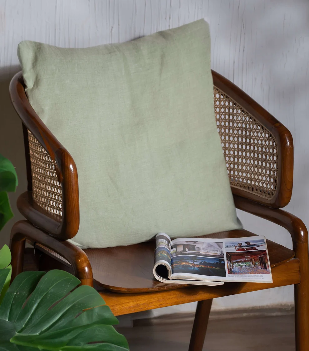 Linen Cushion cover in Tea Green color on a wooden chair