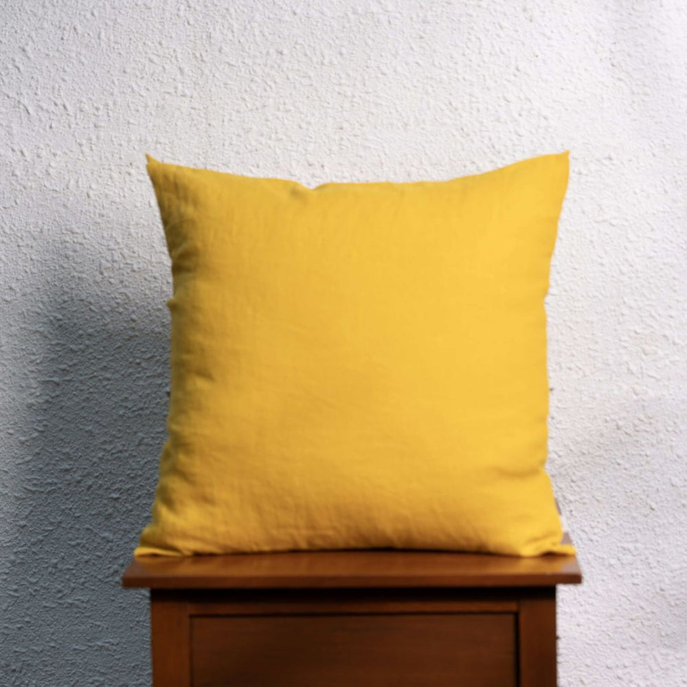 Nugget Gold Linen Cushion Cover On a Wooden Table
