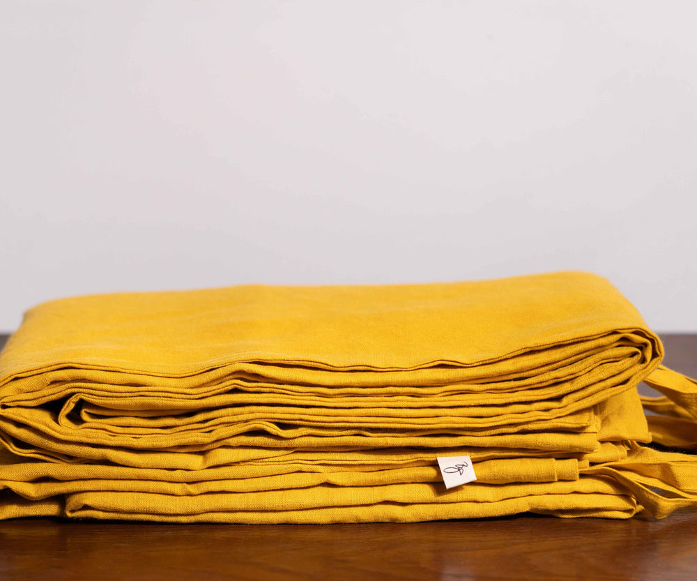 Nugget Gold Linen Duvet Covers On a Wooden Table