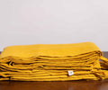 Nugget Gold Linen Duvet Covers On a Wooden Table