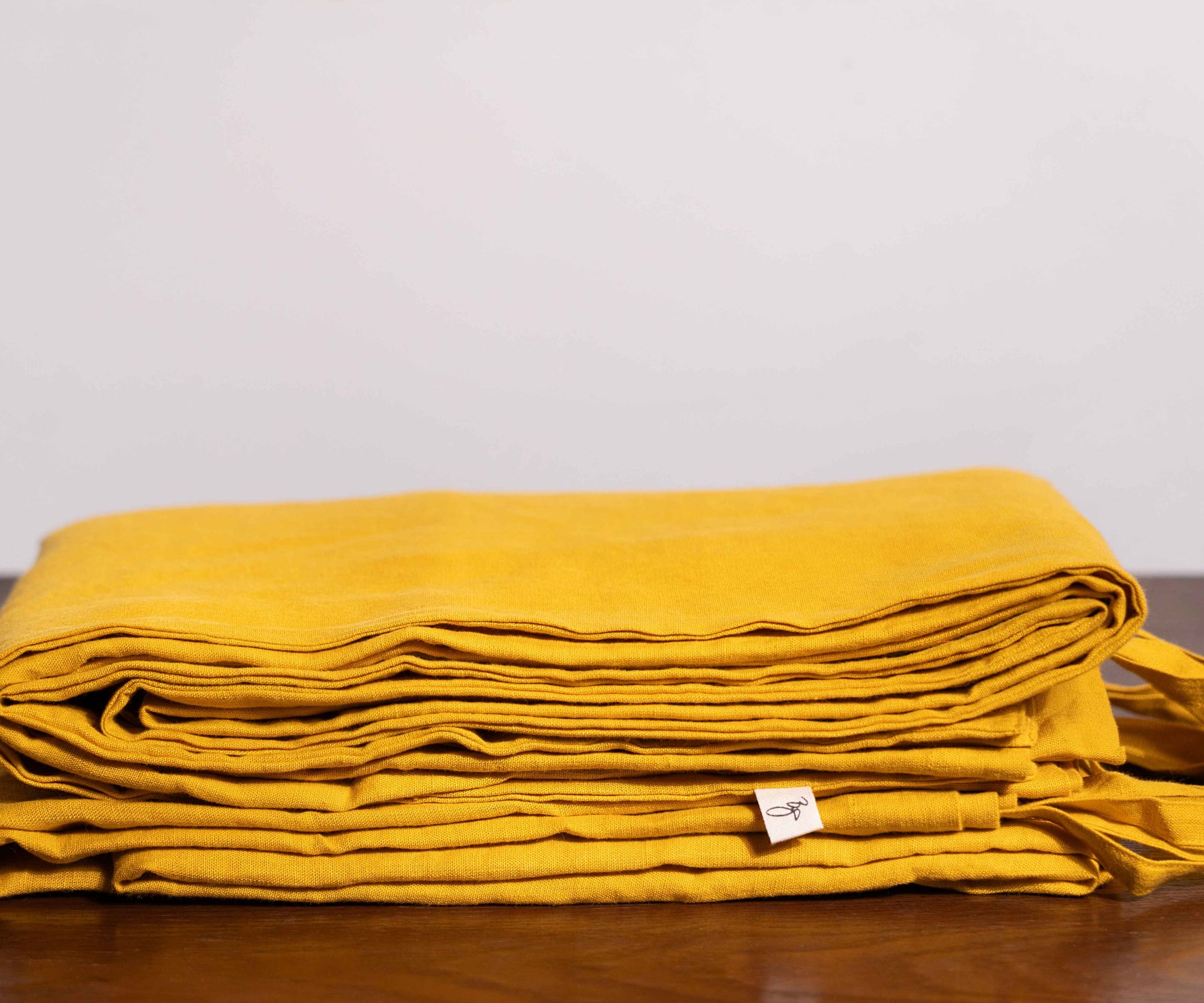 Nugget Gold Linen Duvet Covers On a Wooden Table