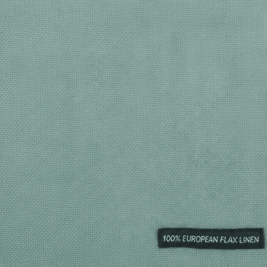 Textile with a '100% Belgian Linen' label on a light green background