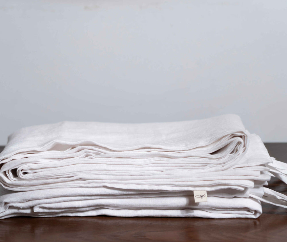 White Linen Duvet Covers On a Wooden Table