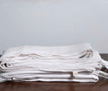 White Linen Duvet Covers On a Wooden Table