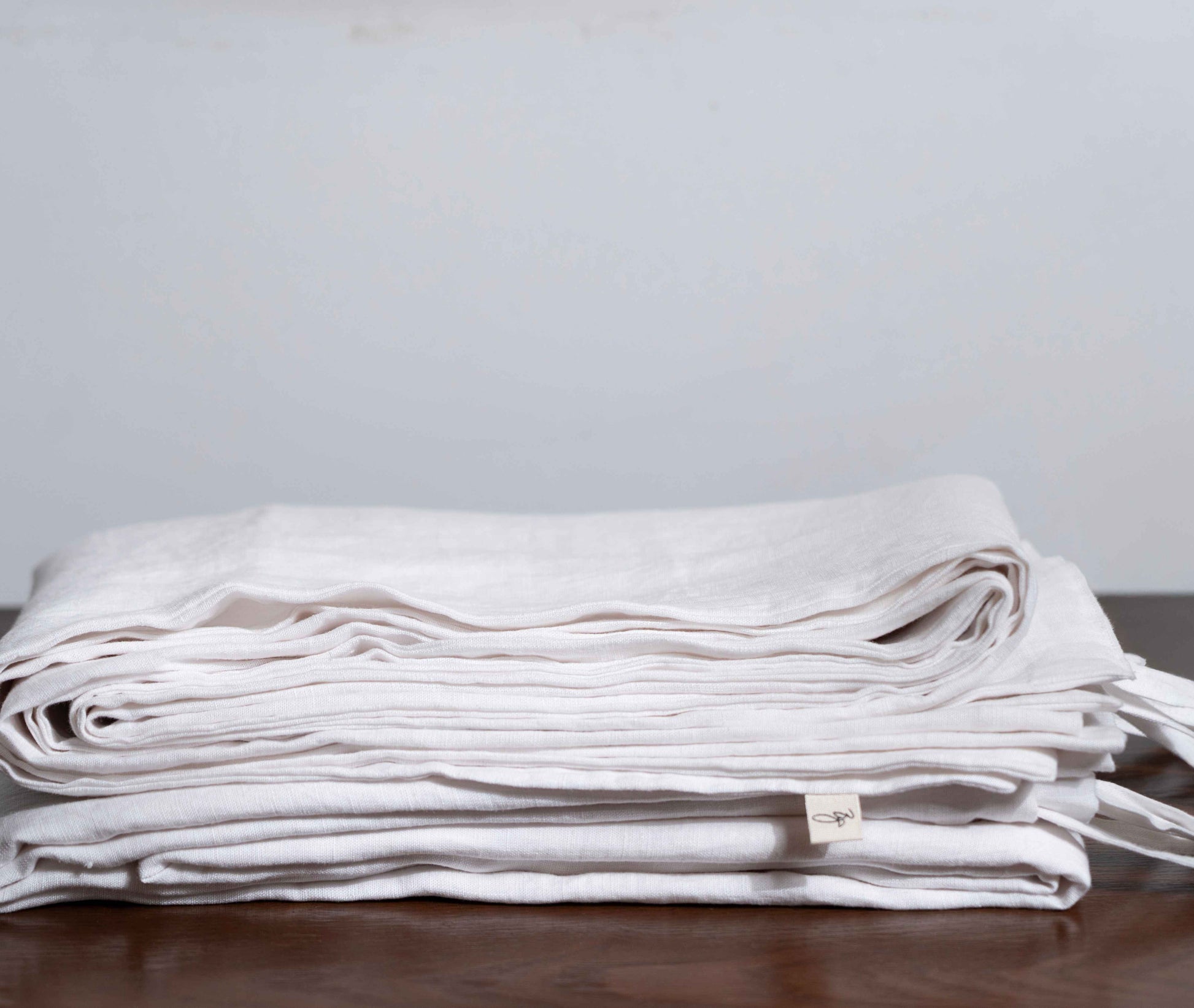 White Linen Duvet Covers On a Wooden Table