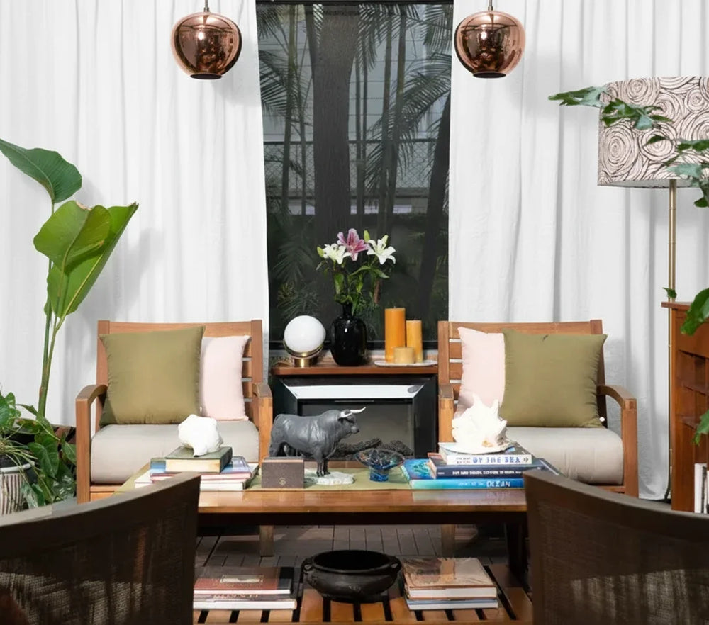 Modern living room with wooden chairs, a coffee table, and decorative items.