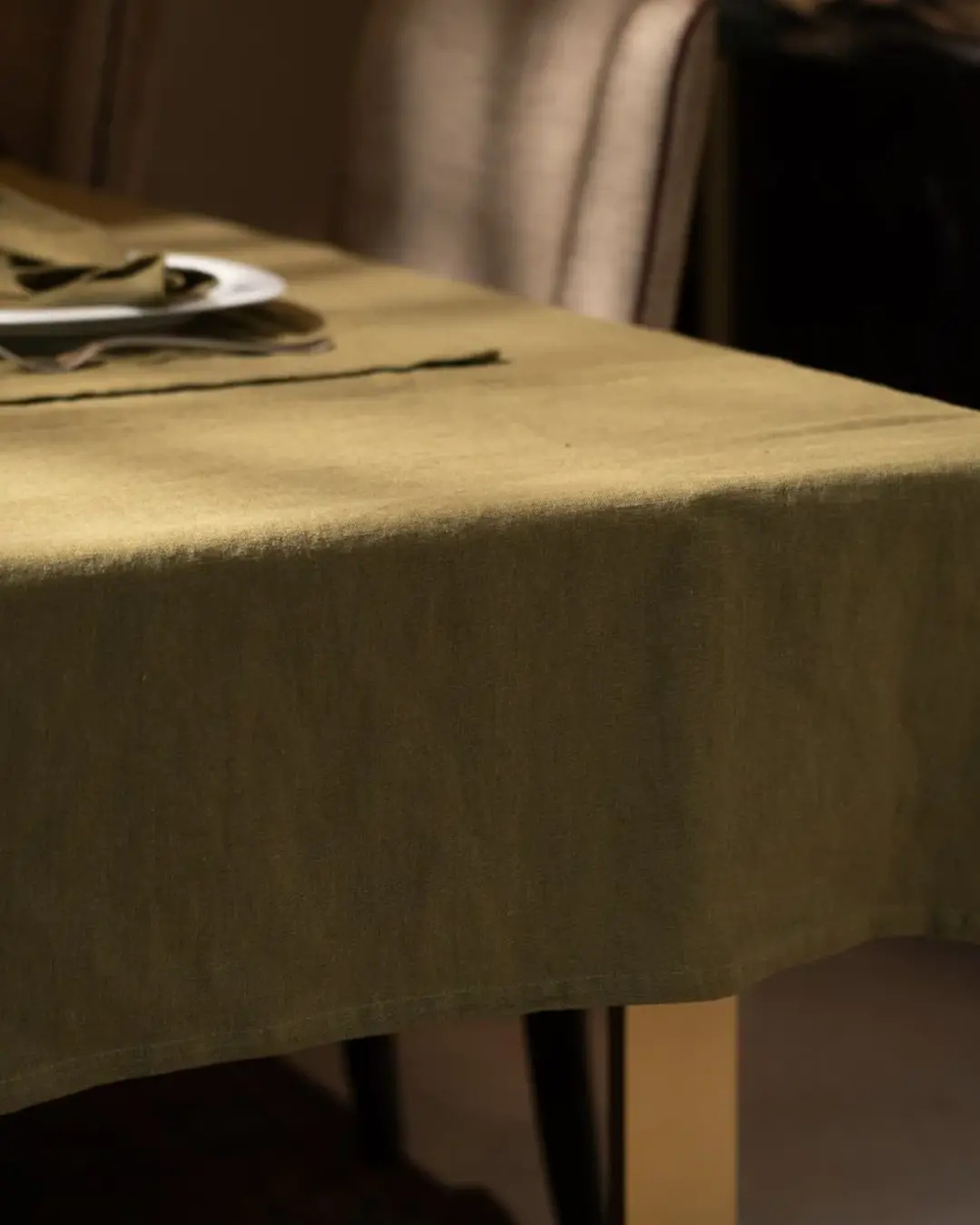Green tablecloth on a table with a blurred background