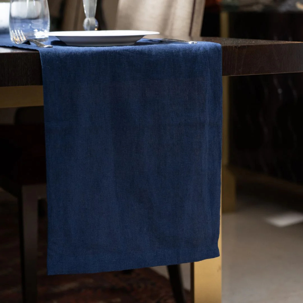 Blue tablecloth draped over a wooden table with a blurred background