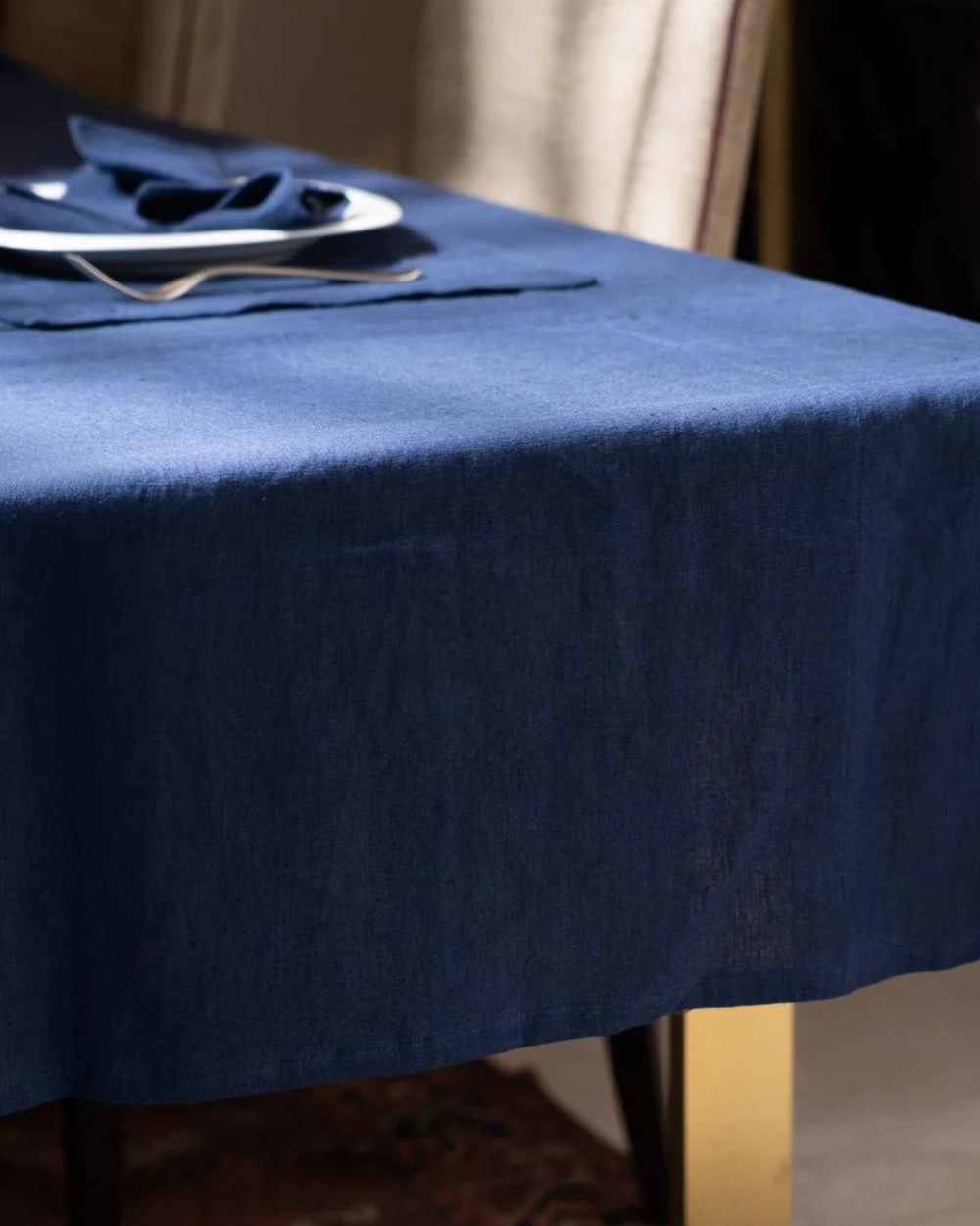 Navy blue tablecloth on a table with a blurred background
